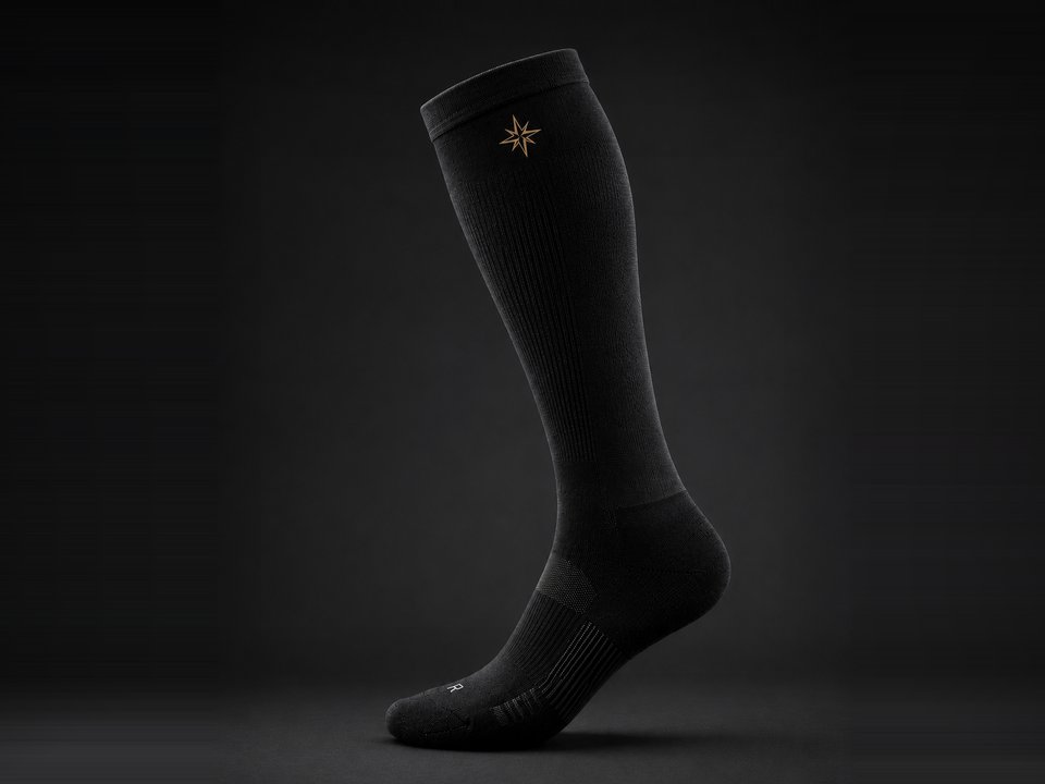 TRUE NORTH Longhaul Compression Sock in merino wool, gold compass mark on the cuff