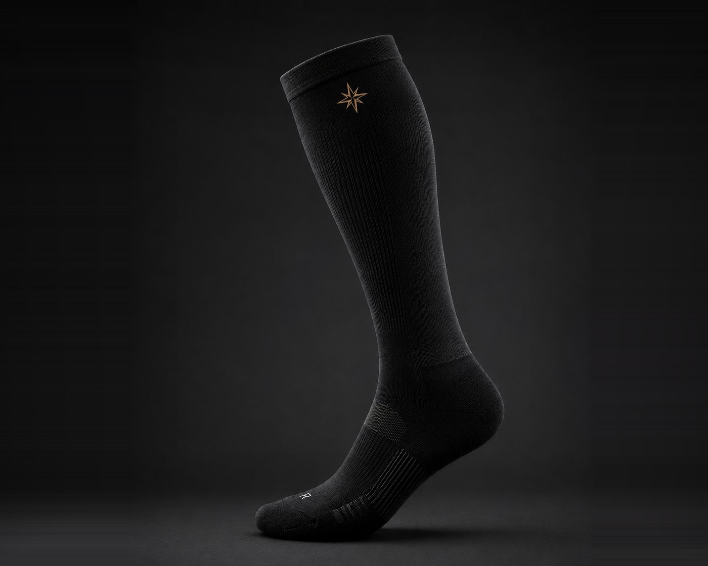 TRUE NORTH Longhaul Compression Sock in merino wool, gold compass mark on the cuff